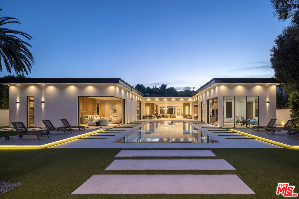 Step into a league of your own at 4640 Petit Ave, where unmatched luxury collides on a sprawling 1.2-acre estate in the prestigious Encino Hills. Positioned on completely flat, fully usable landan ultra-rare findthis 12,034 sq. ft. architectural marvel is designed for the professional who demands it all. Unlike hillside properties, this estate's flat terrain maximizes every square foot of its 1.2 acres, allowing for vast indoor and outdoor entertaining spaces, a full-size basketball court, staff parking, and a resort-style zero edge pool. More space, more exclusivity, and more freedom to live large and entertain on a scale that few can even dream of. This isn't just a home; it's your personal paradise, where boundaries are pushed, and limits don't exist.From the moment you arrive, the property's grandeur takes your breath away. The grand driveway, lined with 13 towering palm trees, welcomes you to a home that offers endless opportunities for both indoor and outdoor enjoyment. This home features 12-foot pocket doors to a lush, resort-like backyard all surrounded by flat, beautifully landscaped grounds. The gourmet kitchen and butler's kitchen, equipped with top-of-the-line Miele appliances and dual islands, is an entertainer's dream. Whether you're hosting casual gatherings or formal dinner parties, this kitchen offers both the space and functionality to handle it all.Meticulously designed by a renowned professional design team who crafted every detail with timeless elegance in mind the home embraces a palette of earthy, natural tones that exude sophistication and warmthcolors and materials chosen to endure the test of time. For the ultimate hangout spot, the full game bar is equipped with four mounted TVs, so you and your friends will never miss a game. Whether you're enjoying drinks, catching a big sporting event, or hosting a poker night, this bar is built for serious fun. And for those who love to stay active, the front yard boasts a full-size basketball court, complete with Kobe Bryant logos, providing the perfect space to shoot hoops, host friendly games, or unwind with the guys.One of the home's most unique and stunning features is the majestic olive tree, an impressive centerpiece that brings a touch of nature right into the core of your living space. This natural element enhances the indoor-outdoor connection and adds an elegant, timeless touch to the home's design. And it doesn't stop there. Car enthusiasts will be captivated by the parking showroom, complete with sleek epoxy flooring.4640 Petit Ave is more than just a homeit's a statement of prestige, space, and lifestyle for those who demand the best. With its expansive flat acreage, state-of-the-art amenities, and timeless design, this estate offers an extraordinary opportunity to live, entertain, and enjoy life on a scale few can match.