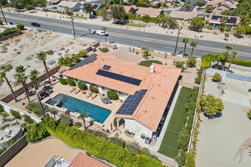 Welcome to 2280 N. Sunrise Way, an updated gated estate nestled on a half-acre in central Palm Springs. This custom single-level home boasts breathtaking mountain views and a separate guest house.The custom single-level home offers over 3,900 square feet of living space, featuring high ceilings, a dual side fireplace that connects the living room to the kitchen, and a culinary space that includes a large granite island, stainless appliances, and a dining area.The three en-suite bedrooms include a spacious primary suite with a spa-style bath, dual vanities, a soaking tub, a walk-in shower, and a custom closet. A separate media room with built-in sound and theater seating provides entertainment options for relaxation or hosting events.In 2021, an attached but separate guest house with a chef's kitchen, high-end finishes, in-unit laundry, and a private entrance was added. This guest house is ideal for accommodating guests, multi-generational living, or generating rental income.Outside, the resort-style backyard features a 52-foot saltwater pool, waterfall, spa, firepit, mountain views, and an expansive patio framed by mature desert landscaping and custom lighting. Additional features include Tesla-owned solar with battery backup, an EV charger, and a finished two-car garage. The property is private, polished, and move-in ready.