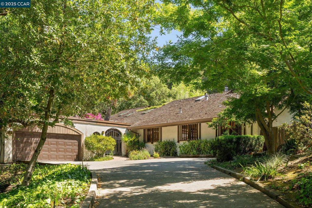 This is your chance to restore or reimagine a truly special property just minutes from downtown. Bring your vision, contractor, & creativity—opportunities like this are rare. Tucked above a coveted, tree-lined street in a peaceful setting, this distinctive home is reminiscent of timeless Santa Barbara charm. Enter through a covered courtyard into a light-filled foyer that connects the Main House, Adjacent Studio, and Upper Bonus Level. MAIN HOUSE: Spacious formal living & dining rooms overlook the side & backyards, with views toward a central atrium. A loft/office floats above the living room. Expanded kitchen with fireplace is adjacent to a cozy family room. Primary suite with ensuite bath & 2 additional bedrooms share a hall bathroom. STUDIO: Spacious with built in cabinetry, a fireplace, powder room, & courtyard views. A separate side entrance offers ADU potential. UPPER BONUS LEVEL:Bedroom/guest suite/study. A full bathroom and 3 storage areas ~ a natural retreat with endless possibilities.
