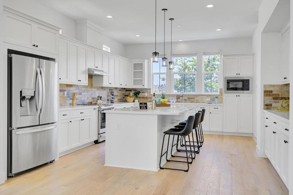 Nestled in the upscale Compass Bay community, this pristine North-eastfacing townhome built in 2021 with 4 beds and 3.5 bath offers modern elegance across three levels. The first floor welcomes you with a spacious twocar attached garage and a versatile bedroom with ensuite full bathroomperfect for guests or multigenerational living. The second floor showcases an open-concept living and dining area flowing seamlessly into a covered patio, centered around a chefs kitchen featuring gleaming quartz countertops, white cabinetry, stainlesssteel appliances, and a large island bathed in natural light. On the top floor, retreat to the luxurious primary suite complete with ensuite bath and walkin closet, alongside two additional bedrooms connected via a Jack-and-Jill bath, plus a dedicated laundry nook and linen storage. Premium features include central HVAC, an inunit washer/dryer, EV charging outlet, wholehome solar panels, and a water softener system. Ideally located just steps from the Meta shuttle stop and minutes from major tech employers, Dumbarton Bridge, I880, and scenic nature trails.