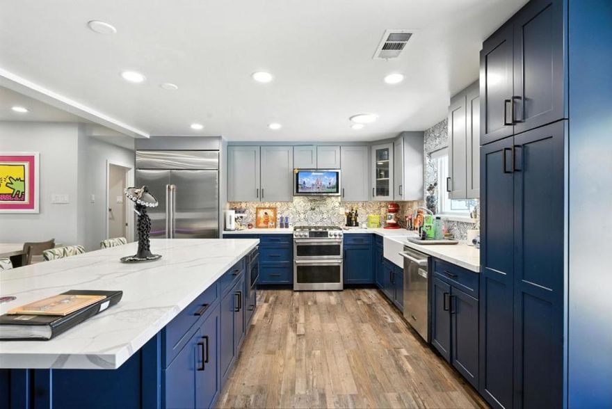 Welcome to your dream home! Nestled on an oversized 14,810 sq ft lot, this beautiful single-family residence offers 4 spacious bedrooms, 3.5 bathrooms, and 2,125 sq ft of living space. Inside, you're greeted by warm wood flooring and a bright, open living area perfect for family gatherings and entertaining. The heart of the home is the modern kitchen, featuring two-toned cabinetry, stainless steel appliances, ample storage, and a large island counter ideal for meal prep or casual dining. Glass doors off the kitchen lead to your backyard retreat, seamlessly blending indoor-outdoor living. Discover generously sized bedrooms, including a luxurious primary suite with a walk-in closet and an ensuite bathroom. Step outside to your private backyard oasis complete with a heated pool, hot tub, waterslide, outdoor sound system, and patio, all designed for unforgettable summer fun. A separate entrance to the yard ensures privacy and convenience, while RV parking with its own rear access adds versatility. Additional highlights include a commercial-grade solar system and plenty of room to entertain or relax under the sun or stars. This home is the perfect blend of comfort, functionality, and resort-style living. Dont miss your chance to own this incredible property!
