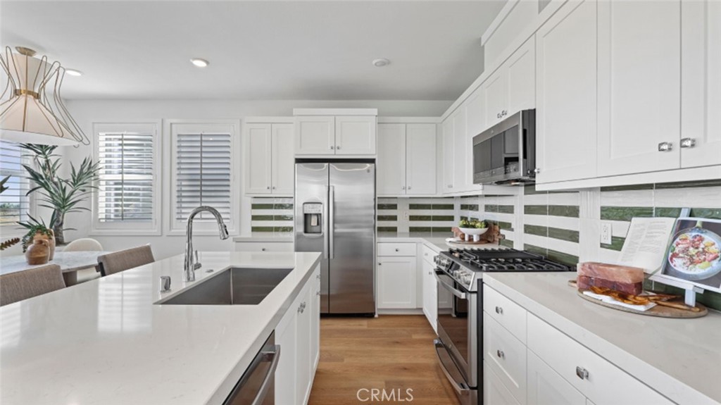 This new three-story home is host to a private den on the first level. On the second floor, an inviting open-concept layout is adjacent to a bedroom and full bathroom, with a deck offering convenient outdoor access. Two additional bedrooms can be found on the third floor, including the owner’s suite with an en-suite bathroom and walk-in closet.