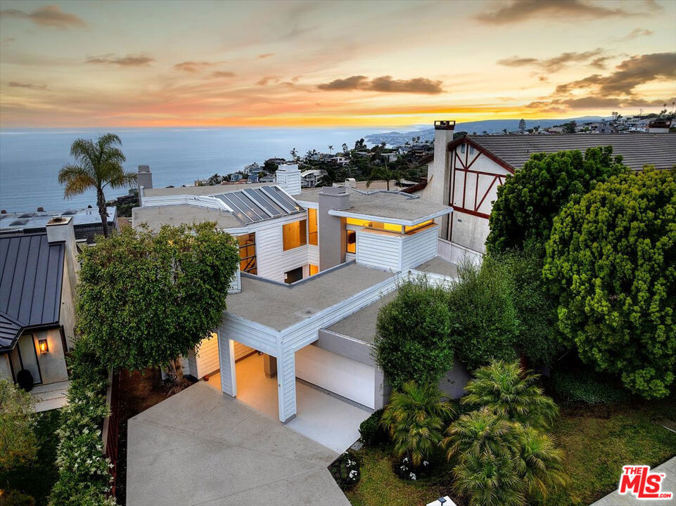 Perched above Victoria Beach at the end of a quiet cul-de-sac, 741 Marlin is nestled in the coveted Portafina neighborhood of Laguna Beach. This transitional contemporary home, thoughtfully designed with clean lines, warm wood accents, and expansive walls of glass, showcases stunning ocean views and abundant natural light throughout. Beyond a gated courtyard, an oversized pivot door welcomes you into a sunlit entryway. Featuring 4 bedrooms and 2.5 baths, the main level features an open-concept kitchen adjoining a cozy lounge area, a vaulted-ceiling living room that opens seamlessly to a spacious deckperfect for relaxing or entertaining with coastal sunset viewsand a guest bedroom with direct access to the courtyard. The kitchen is beautifully updated with high-end appliances, seamless cabinetry, a large island with breakfast bar, and access to the outdoor deck for effortless al fresco dining. Adjacent to the kitchen is a separate family room with fireplace nearby a private sauna and standing shower, creating a luxurious, spa-like retreat.Upstairs, the primary suite features multiple skylights that fill the space with natural light, a generous walk-in closet, a dual-vanity bathroom, and panoramic views from a private ocean-view balcony. Two additional guest bedrooms down the hall share a modern remodeled bathroom. Located just minutes from Moulton Meadows Park, scenic hiking trails, pristine beaches, and the vibrant shops and galleries of Downtown Laguna, this home offers the perfect blend of peaceful coastal living and convenient access to everything Laguna Beach has to offer. Experience the lifestyle and sweeping views of 741 Marlin Drive in person---you won't want to leave.