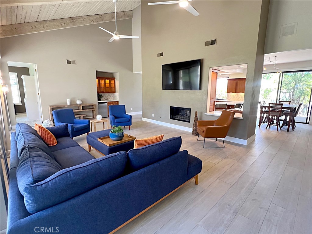Quietly tucked away on a cul-de-sac within Mission Hills Country Club, this two bed/two full bath condo offers an abundance of upgrades. A private luxury getaway with peek-a-boo mountain views and uninterrupted vistas of the famed Dinah Shore course. Inside the gated front courtyard enjoy a professionally landscaped desert oasis. The interior features updated wood-look ceramic flooring and high-gloss 6” real wood trim. A newly remodeled open kitchen with stunning quartz countertops and modern tile backsplash, new double sink with touch on/off faucet, dimmable LED lighting, plus a 42” sub-zero paneled refrigerator, Dacor gas cooktop and new Samsung Flex Duo oven - its two separate ovens in one. Living room has a matching wet bar area with sink and mini fridge. A slider opens off the dining area to the courtyard for morning coffee. New Hunter Douglas smart powered designer roller shades in main living, dining and kitchen areas and blackout shades in bedrooms. Thoughtful upgrades and contemporary finishes can be found throughout. Generous master suite has amazing views and a spa bath featuring custom dual marble-top vanities (extra tall for the Gents) and a large tub/shower. Guest bedroom and bath have consistent highly upgraded finishes, lighting and closet organizers. A large, fenced rear patio offers late afternoon shade and plenty of entertaining space along with fabulous views of hole #11, all safely outside the range of an errant golfer. For energy savings year round, the unit has a new Lennox 28 SEER HVAC system. The most energy efficient AC unit available anywhere. Large two car + golf cart garage has built-in storage. Community pool and spa nearby. No steps or stairs. Updated 2121 land lease is paid. HOA road resurfaced in fall of 2024. Near shopping (6 minutes to Costco), dining, Eisenhower Hospital & the new Disney Cotino development. Mission Hills Country Club offers three championship golf courses, expansive clubhouse, restaurants, fitness center, tennis, pickleball, croquet and bocci. Membership required. Furnishings are available.