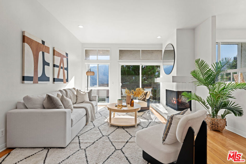 Tri-Level Townhome with Panoramic Mountain & Treetop Views! This thoughtfully designed 3-bedroom, 3-bath tri-level townhome of nearly 2,100 sq ft in the coveted Palisades Highlands is ideal for those who value both comfort and serenity. From every room, sweeping mountain and treetop vistas create a stunning backdrop, while multiple balconies and patios on each level extend living space outdoors and showcase the tranquil natural surroundings. Enter directly from the attached two-car garage (no steps!) into the open kitchen, dining, and living area. A welcoming fireplace anchors the living room, offering a warm and inviting setting that flows seamlessly to the outdoors-perfect for everyday living or entertaining. Upstairs, a vaulted bedroom with its own fireplace and private balcony provides a serene retreat, ideal as a second primary suite, media lounge, or guest space. Downstairs, two additional bedrooms and two baths include a spacious primary suite with walk-in closet, a versatile office/den nook, and direct access to a private patio with mountain views. The flexible floor plan easily adapts to modern lifestyles, whether for remote work, hosting guests, or multi-generational living. Community amenities include a pool, spa, fitness room, sauna, and tennis courts, all set within beautifully landscaped grounds overlooking verdant hills. Just minutes from hiking trails, the ocean, and Palisades Village, this home blends natural beauty, modern convenience, and calm sophistication. Experience unmatched privacy, breathtaking views, and the best of Highlands living-schedule your private tour today.