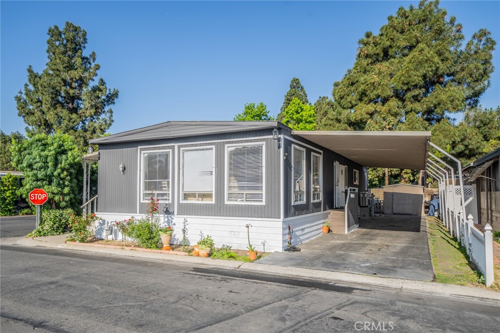 Spacious 3 Bedroom, 2 Bath Barrington Manufactured Home on a corner lot, featuring an open floorplan, living room with wall electric fireplace, kitchen with huge island perfect for entertaining or family gatherings, plus 2 bonus rooms easily used as a guest room, den, or office, master bedroom has an electric fireplace too. Located in the heart of Anaheim at the Rio Vista MH Park with easy access to the 91/57 Freeways, restaurants, entertainment / amusement parks, shopping, and much more! This beautiful home won't last long...set your appointment today!