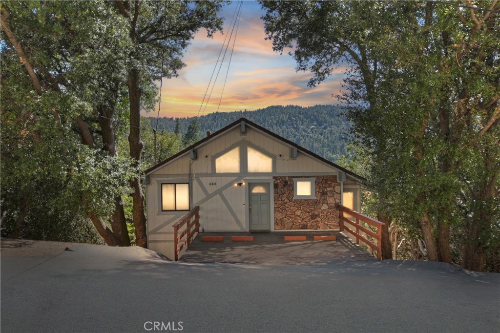 Tucked in the trees, this mountain home comes with the neighboring lot, included, offering over a quarter of an acre of land! Enjoy the ease of level entry, offering an open-concept layout ideal for both relaxing and entertaining. Over 2500 sq ft, featuring expansive living space with seamless flow between the kitchen, dining, and living areas. Entry level includes; loft that is perfect for a home office, hobby area, or guest overflow, 2 Bedrooms, and 1 full bathroom. Second level offers main living space with fireplace, which has access to the back deck, perfect for relaxing and taking in the mountain views. Master and bathroom on second level also. The third level offers a spacious family room with fireplace that provides additional gathering space with access to lower deck, great for more family fun! Laundry room located on the third level also. Additional lot square footage offers room to expand for a possible garage or simply enjoy the added privacy and outdoor space. Decks have been completely redone! Whether you are looking for a full-time residence, weekend escape, or investment opportunity this mountain home has what you're looking for!