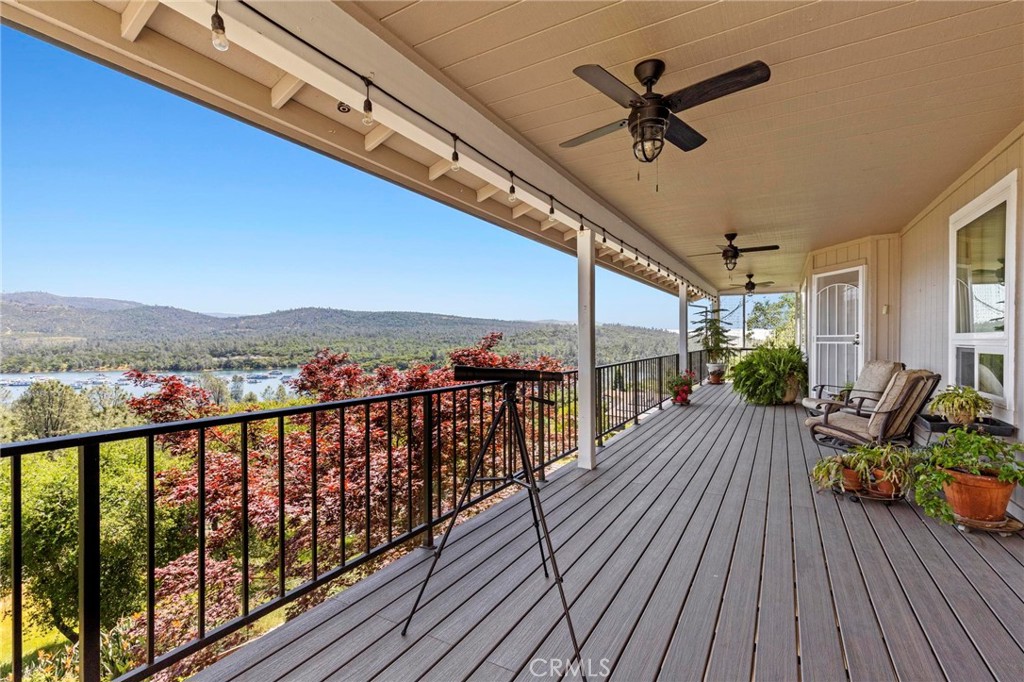 Welcome to LAKEVIEW LUXURY living at its finest! Perched above Lake Oroville with panoramic water views from both levels, this 3,165 sq. ft. residence is a rare blend of elegance, comfort, and thoughtful design. With 4 bedrooms, 2.5 bathrooms, two stories, and two spacious living areas, this home is ideal for those seeking upscale lake living with room to relax and entertain. Step inside the formal entry and immediately notice the luxury finishes throughout — from the travertine floor entry to the heated travertine floors and marble touches in the spa-like primary bathroom, to the warm ambiance created by the wood stove upstairs and pellet stove downstairs. The primary suite is a true retreat with a walk-in closet, soaking tub, and serene views. The gourmet kitchen features a brand-new dishwasher and flows seamlessly into the upper-level living space and covered Trex deck, where ceiling fans and lighting enhance outdoor dining and sunset viewing. A second covered porch on the lower level offers additional space to enjoy the lake views. Practical features abound: central heat and air, owned solar and propane tank, backup generator, and a fire sprinkler system around the home’s exterior offer peace of mind. The landscaped front and terraced backyard are served by a drip irrigation system and include fruit trees and established gardens. Other highlights include a large interior laundry room with abundant storage, and an attached 2-car garage. Multifamily/shared living potential with split-level setup. Rare opportunity to own an elevated stick-build home in the sought-after Kelly Ridge neighborhood.
