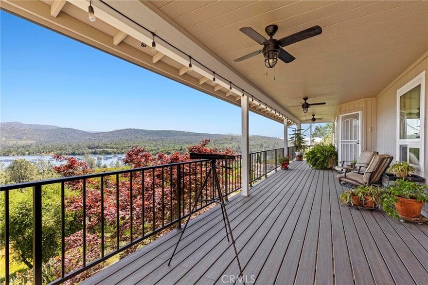 Welcome to LAKEVIEW LUXURY living at its finest! Perched above Lake Oroville with panoramic water views from both levels, this 3,165 sq. ft. residence is a rare blend of elegance, comfort, and thoughtful design. With 4 bedrooms, 2.5 bathrooms, two stories, and two spacious living areas, this home is ideal for those seeking upscale lake living with room to relax and entertain. Step inside the formal entry and immediately notice the luxury finishes throughout — from the travertine floor entry to the heated travertine floors and marble touches in the spa-like primary bathroom, to the warm ambiance created by the wood stove upstairs and pellet stove downstairs. The primary suite is a true retreat with a walk-in closet, soaking tub, and serene views. The gourmet kitchen features a brand-new dishwasher and flows seamlessly into the upper-level living space and covered Trex deck, where ceiling fans and lighting enhance outdoor dining and sunset viewing. A second covered porch on the lower level offers additional space to enjoy the lake views. Practical features abound: central heat and air, owned solar and propane tank, backup generator, and a fire sprinkler system around the home’s exterior offer peace of mind. The landscaped front and terraced backyard are served by a drip irrigation system and include fruit trees and established gardens. Other highlights include a large interior laundry room with abundant storage, an attached 2-car garage, and a second parcel of vacant land at the backside of the property that can be purchased separately for added privacy. Multifamily/shared living potential with split-level setup. Rare opportunity to own an elevated stick-build home in the sought-after Kelly Ridge neighborhood.