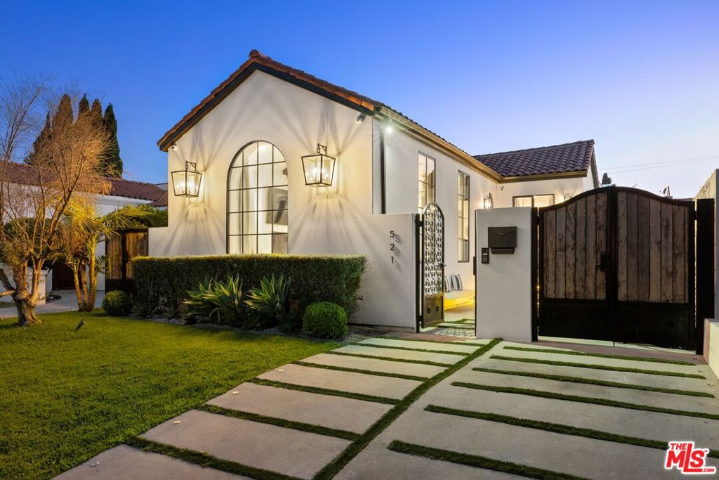 Elegantly transformed and rich in character, this gated single-story Spanish residence blends classic 1920s architecture with finely crafted modern updates. The main house offers 3 bed and 3.5 bath, while the newly built ADU includes outdoor kitchen, 1 bed (no closet) and 1 bath - perfect for guests, a gym, or home office. Behind the gates, a beautifully landscaped front courtyard with a fire feature sets the tone for the warm welcome. The light-filled living room features soaring beamed ceilings and a dramatic fireplace, flowing into a generous dining room and marble-clad chef's kitchen with custom cabinetry, high-end appliances, and built-in breakfast nook. The spacious primary suite boasts a walk-in closet, designer bath, and glass doors opening to the private backyard with new ficus hedges, swimmer's pool, jacuzzi, and waterfall. Premium finishes include wide-plank hardwood floors, tall interior doors, surround sound, security system with CCTV, and sleek fixtures throughout. The ADU features a luxe outdoor kitchen, bar area, and a rooftop deck with views of the Hollywood Sign. Home was completely remodeled in 2022. 521 N Formosa Ave is a rare opportunity you won't want to miss. Schedule your private showing today. Minimum 14 mo lease.