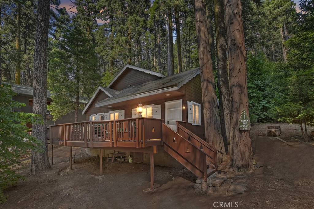 Looking for your mountain getaway or full-time home with a history dating back to the early 1900's? Yes, this would be it. Owned by the same family since 1911. The homme was rebuilt in the 1950's and then expanded and renovated in the 1980's. Family believes the original fireplae is still standing with a painting of the original cabin adorning the fireplace mantel. So many wonderful memories were made here throughout the last 100+ years including family members and their friends fortunate enough to join in with the original build and then the rebuild. We'll be happy to show you the photo albums detailing the activities throughout the decades. Cozy front porch faces the seasonal creek. With two oversized bedrooms including a true primary suite upstairs, you'll also enjoy a bed and bath on the main level. Sellers just completed some bigger ticket improvements including a new roof, exterior paint, new fireplace insert, and we have a clear pest control report on file, too. Offered mostly furnished, this darling cabin is awaiting it's next chapter as a cherished mountain retreat.