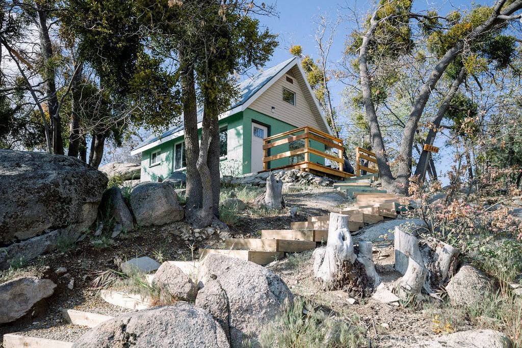 Active Airbnb tennants on weekends so please contact listing agent for showing times.
PRICE SLASHED – SELLER SAYS BRING ALL OFFERS!
Stop scrolling. Seller is serious, price is cut, and the call is simple: bring your offer.
Fully furnished and turn-key, this mountain retreat isn’t just cozy—it’s a proven income generator. In 2023 it brought in $28,636, and in 2024 it hit $29,238 in verified Airbnb rental income, based on just under 200 days of occupancy. Go ahead—book it more and cash in, or use it yourself for the perfect getaway the other half of the year. It’s a win-win. Reports are available.
Tucked among towering pines and granite boulders, this cabin blends rustic charm with modern comfort. Enjoy a lofted bedroom with classic cabin beams, an open-concept living and dining space with panoramic mountain and forest views, a private patio for entertaining, and a fully stocked move-in ready interior.
Minutes from hiking, dining, and year-round adventure, this property offers both privacy and immediate rental income potential. This isn’t just a cabin—it’s a lifestyle investment. Seller says: bring all offers.
Boom. Mic drop. Your move.