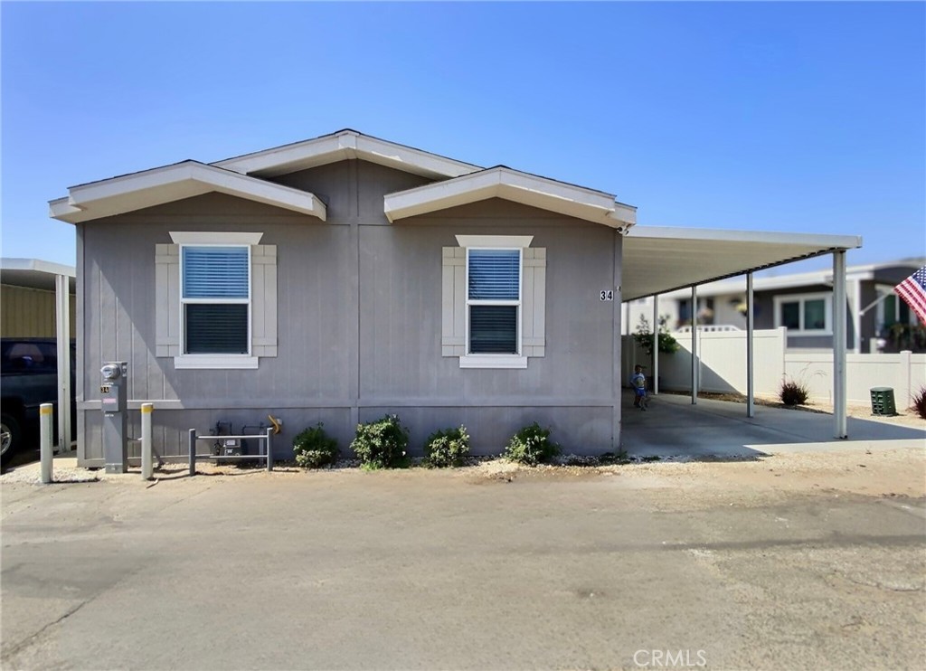 Welcome to this spacious and well-maintained manufactured home located in a desirable and growing community. Featuring an open floor plan with abundant natural light, this home offers the perfect combination of comfort and functionality.
The interior boasts a large living room that flows seamlessly into the dining area and kitchen, ideal for both everyday living and entertaining. The kitchen is equipped with ample cabinetry, a breakfast bar, and modern countertops. The home offers three bedrooms and two bathrooms, including a primary suite with dual sinks and an extra storage cabinetry.
Additional highlights include updated flooring throughout, an indoor laundry area, and central heating and cooling. The exterior features a covered carport with parking for multiple vehicles, low-maintenance landscaping, and a fenced in patio.
Situated in a family-friendly community, this property provides convenient access to local schools, shopping, dining, and major freeways. With its spacious layout and modern finishes, this home is an excellent opportunity for buyers seeking quality and value.