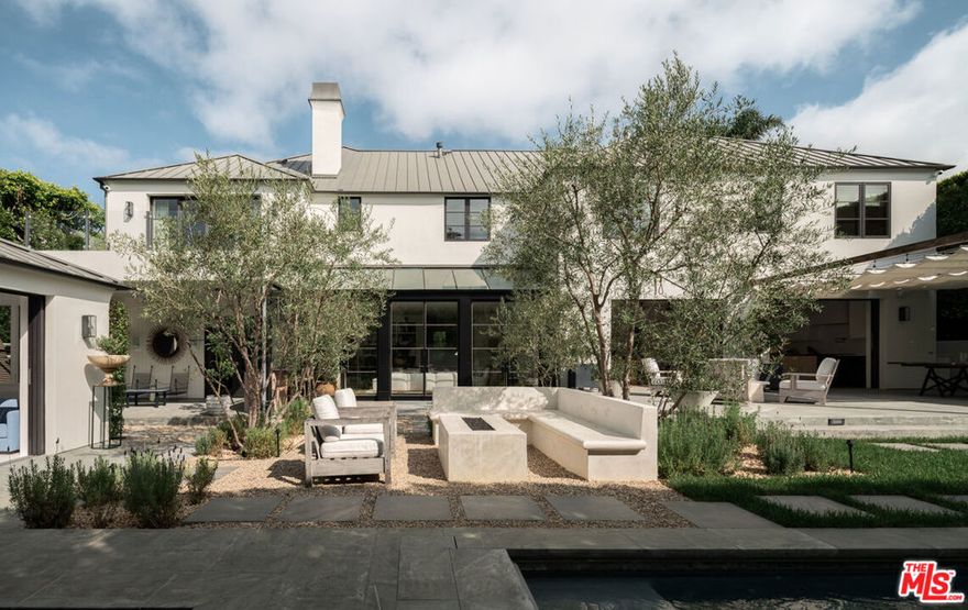 Welcome to 14952 Alva Drive, a meticulously designer done home in the prestigious Huntington Palisades. Recently renovated by Becker Studios, this gated residence sits behind mature landscaping, offering exceptional privacy and effortless sophistication. Thoughtfully designed to balance refined elegance with laid back coastal living, the home embodies a timeless sense of warmth and tranquility. Boasting just under 7,000 square feet of living space on a 12,000+ square foot lot, the property features six spacious bedrooms and eight bathrooms, perfectly suited for both everyday living and entertaining. The interiors are light-filled and inviting with high ceilings and incredible scale throughout. The bright, flowing floor plan showcases curated materials and meticulous craftsmanship, featuring a formal living and dining room, family room, separate media room, kitchen and dining area, two powder bathrooms, 5 spacious bedrooms with en-suite bathrooms upstairs including a separate office and a finished attic space. Light illuminates the main living area, where large glass doors frame views of olive trees and the lush backyard beyond. The chef's kitchen, anchored by custom cabinetry and high-end appliances, features sliding glass doors that open out onto the outdoor patio and fireplace, perfect for indoor and outdoor entertaining and dining al-fresco. A beautifully integrated pool house offers flexible use as a guest suite with a sauna and cold plunge, private office, or creative studio. Outside, the resort style grounds include a sparkling pool, cold plunge, outdoor shower and spa surrounded by multiple lounging and dining areas that invite year round enjoyment. Every detail of the home has been considered for comfort, function, and design integrity. State of the art technology, including a Crestron home automation system, enhances daily living with effortless control and modern convenience. A rare offering where architecture, comfort, and location converge in one of the city's most sought-after enclaves. This is an incredible opportunity to skip the rebuild and come back home to the one of the best homes in the Huntington.
