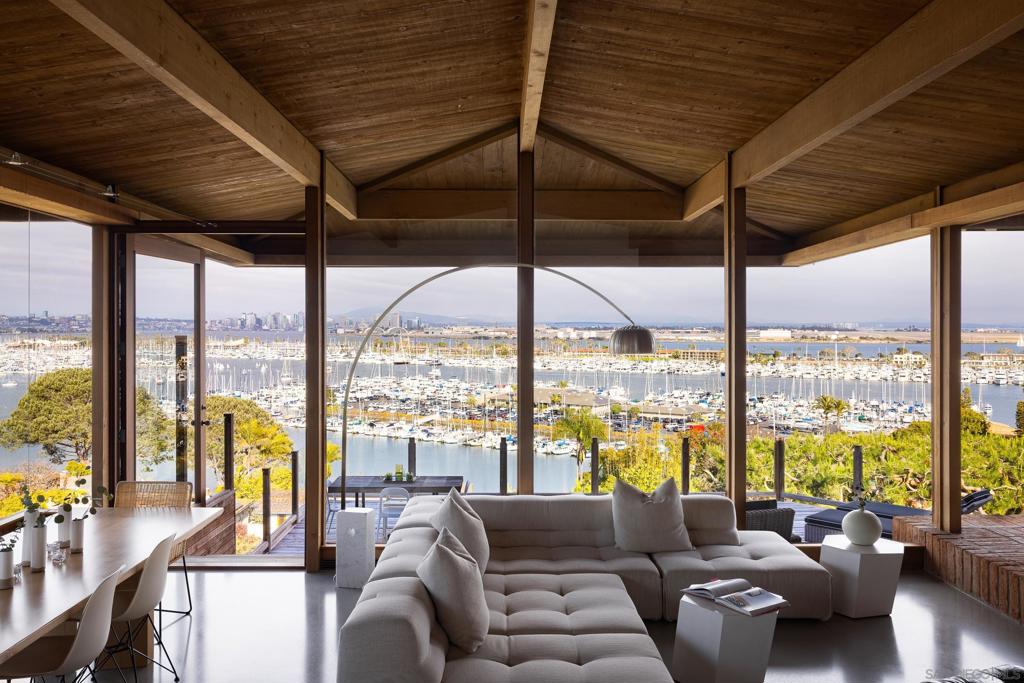 Imagine yourself residing in this completely remodeled masterwork by architect Kendrick Bangs Kellogg. Enjoy expansive, and very unique views of Shelter Island, San Diego Harbor, Downtown and Mexico (not to mention snow-capped mountains in the winter) within close proximity to the boating community. Newly installed old-growth mahogany flooring and Honduran mahogany windows and white oak cabinetry meets the original structure's redwood and Douglas fir detailing. Hand-crafted vintage touches by Kellogg and artist James Hubbell meld gracefully with new finishes and systems offering a myriad of jaw-dropping moments throughout the home and landscape. From its highly unique, safe location in Point Loma's highly sought-after La Playa neighborhood, this impossible to replicate home is a short walk to San Diego Yacht Club, Kellogg Beach, Bessemer Path, and all that Shelter Island has to offer.