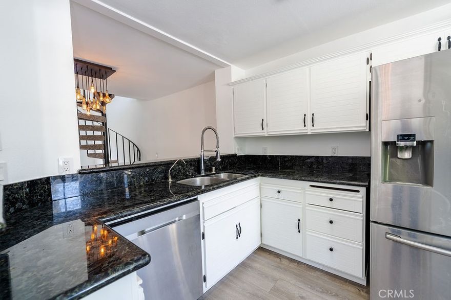 Welcome to this bright and beautifully updated townhome in the gated Arbor Park community of Valencia. The open concept layout features vaulted ceilings, stylish wood look flooring, and a striking spiral staircase. Natural light pours into the living area through large sliders that lead to a private patio, perfect for relaxing or entertaining. Upstairs, the spacious primary suite includes plush carpet, mirrored closets, an en-suite bath, and access to a private balcony. A second bedroom and versatile loft space offer flexibility for guests, a home office, or studio.



Enjoy resort-style living with access to a sparkling pool, spa, and nearby tennis courts. Ideally located within walking distance to parks, grocery stores, the YMCA, and scenic paseos plus just minutes from top-rated schools, College of the Canyons, Whole Foods, Valencia Town Center, and Henry Mayo Hospital. This home offers the perfect mix of comfort, style, and convenience.