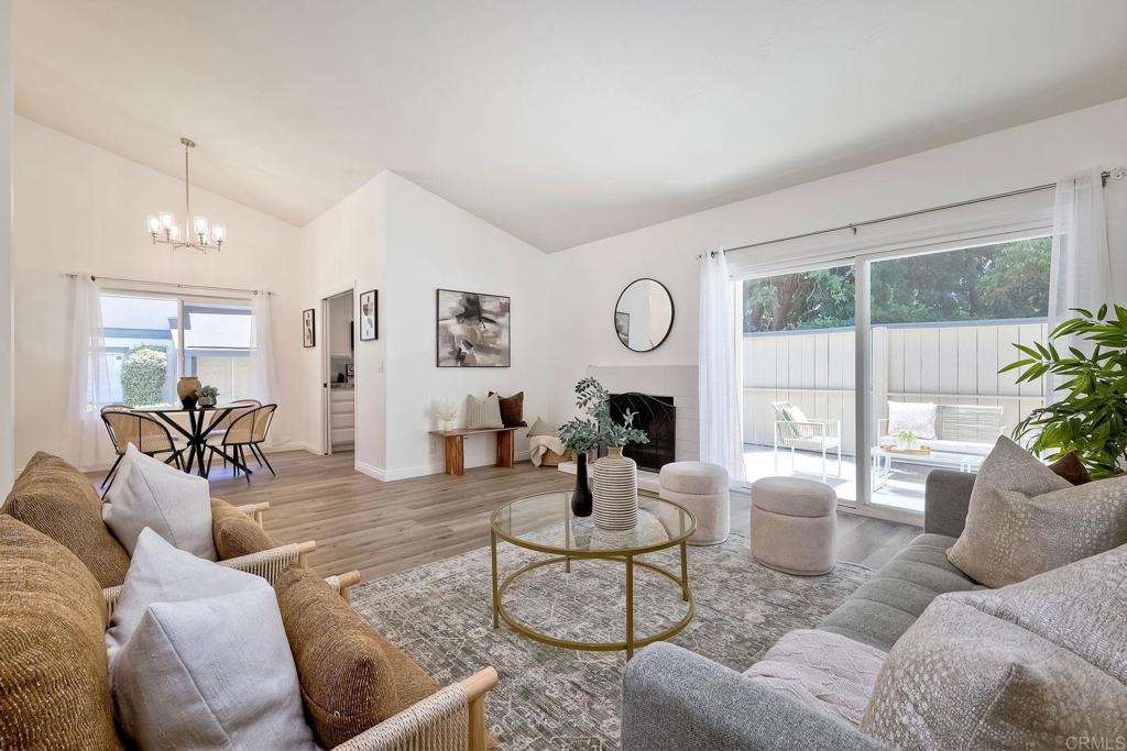 Beautifully Upgraded & Move-In Ready Townhome! Step into this light, bright, and open townhome offering 2 spacious bedrooms, 2 full bathrooms, and 1,175 sq. ft. of thoughtfully designed living space. Soaring vaulted ceilings in the living room create an airy, welcoming feel as you enter. Enjoy cooking in the updated kitchen featuring brand-new stainless steel appliances, crisp white cabinetry, and a scenic view of the backyard. The home boasts new luxury vinyl plank flooring, fresh interior paint, stylish new light fixtures, and a modern tankless water heater for added efficiency. The primary suite is a true retreat, offering generous space, ample storage, and access to a cozy patio—perfect for relaxing or enjoying your morning coffee. The back patio off the living room is PRIVATE & spacious! A detached 2-car garage sits just in front of the home, with a charming path that leads to your front door. Located in a quiet, pet-friendly community of just 48 homes, this property offers a peaceful lifestyle with unbeatable convenience—close to Costco, grocery stores, shopping, and easy freeway access.
