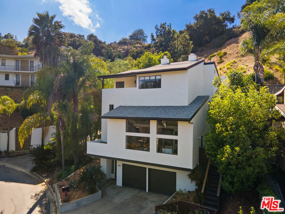 Tucked away in the serene Hollywood Hills, this home offers peaceful hillside living with sweeping canyon and city views, yet sits just minutes from the energy of the city. Enjoy the calm of your own retreat while being only 10 minutes from world-class dining, nightlife, and entertainment. Universal Studios and CityWalk are within walking distance, while the Hollywood Bowl, Runyon Canyon, Studio City, and all of Hollywood are moments away. Inside, the open, airy layout is designed for both relaxation and entertaining. Oversized windows flood the home with natural light and frame the views, while seamless indoor-outdoor flow leads to multiple private terraces. A stunning deck with jacuzzi and fire pit creates the perfect setting for unwinding or entertaining under the stars. The chef's kitchen, generous living spaces, and a primary suite with spa-like bath combine comfort with sophistication.This property is ideal for those who value both convenience and privacy, prioritizing thoughtful design, breathtaking views, and a true turn-key experience.