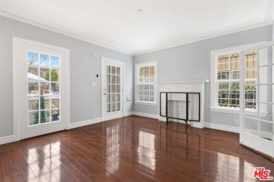 Step into timeless elegance and modern comfort in this beautifully maintained lower 2-bedroom, 1.5-bath residence, located in the highly desirable Beverly Grove neighborhood. This enchanting Colonial-style duplex exudes old-world charm and character, seamlessly blended with contemporary updates and an abundance of natural light that fills every corner of the home. The spacious living room welcomes you with its large picture windows, rich hardwood floors, and graceful architectural details that speak to the home's classic heritage. A formal dining room offers the perfect setting for entertaining. The updated kitchen is both functional and stylish, featuring granite countertops, ample cabinetry, and a convenient laundry room with washer/dryer hookups. The remodeled main bathroom features a  walk-in shower, while the primary bedroom includes a charming bay window and a private half bath for added convenience. Additional features include central heating and A/C, a lovely front patio perfect for morning coffee or evening relaxation, and one gated parking space for security and ease. Perfectly situated in one of Los Angeles' most sought-after areas, this home offers unbeatable proximity to The Grove, LACMA, the Beverly Center, Beverly Hills, and some of the city's best dining, shopping, and entertainment. Available now.