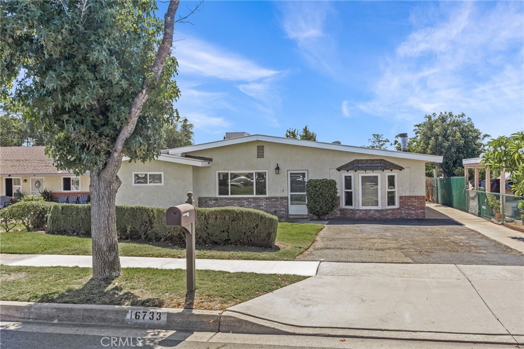 Welcome to 16733 Miller Ave., a spacious single-story home on a large lot, offering a large family room, generously sized bedrooms, and abundant natural light throughout. The fenced backyard features mature pomegranate, orange, and lemon trees—perfect for fresh fruit lovers—along with an outdoor workshop ideal for storage, hobbies, or projects. The well-maintained interior includes convenient indoor laundry and ample parking. Ideally located close to shopping, dining, schools, and major freeways, this home presents a wonderful opportunity to settle in a well-established neighborhood.