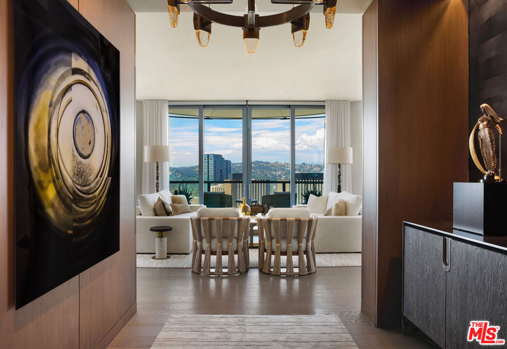 A custom-designed residence by McRae Lambert & Dunn, Residence 26C at the prestigious Century Plaza Park Elm is a one-of-a-kind one-bedroom plus den, offering unparalleled panoramic views to the north and east, facing the Wilshire Corridor and Downtown LA skyline. Upon arrival through a private elevator vestibule, you are welcomed by a grand formal entry foyer that flows into an expansive great room with 10-ft tall floor to ceiling windows. The den features rich walnut paneling and a travertine gas fireplace, creating an atmosphere of warmth and refined sophistication. The Snaidero-designed kitchen is equipped with Miele appliances and a custom slab waterfall island, blending sleek design with exceptional functionality. All rooms have operable windows which is unique in high-rise living. The primary suite offers dual custom Italian-designed closets and a luxurious five-fixture en-suite bath. Smart home features include Dual AC control, a Lutron lighting system and Palladium motorized shades. Residents enjoy world-class amenities including a resort-style pool, state-of-the-art fitness center, steam-equipped locker rooms, screening room, library, game room, personal wine storage, private dining rooms, guard-gated entry, and 24-hour concierge service.