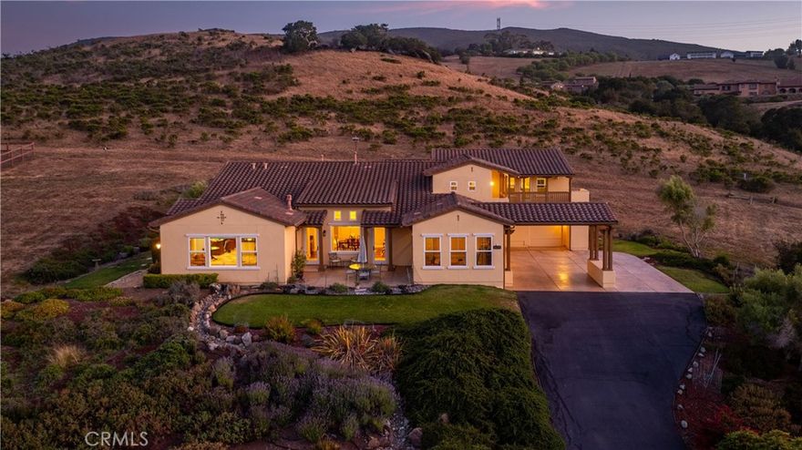A rare opportunity to live in Valle Vista Ranch, one of the most coveted neighborhoods in San Luis Obispo. With spectacular views of Bishop Peak and Madonna Mountain, this 4,100+ square-foot Mediterranean sits on nearly an acre and borders conservation land, providing boundless privacy while still only minutes from downtown. Featuring 4 en-suite bedrooms, including 2 primaries—one on the main floor and a private oasis upstairs with 2 walk-in closets, French doors leading to a large balcony and a show-stopping bathroom with copper fixtures and wet room—the home is perfect for multigenerational living or for someone who simply wants to stretch out. Boasting high ceilings, cozy fireplace, hickory-wood floors, large picture windows, a half-bath for guests on the main floor and a built-in wine bar with fridge in the dining room, this home epitomizes California luxury living. The open floor plan provides a seamless flow between kitchen and living room, perfect for entertaining. Double ovens, farm sink, walk-in pantry and a 6-burner cooktop with griddle makes preparing festive meals a breeze. Want to take the party outside? The lovely courtyard and separate flagstone patio off the kitchen are ready for your next event. And there’s plenty of parking in the 3-car garage or under the Spanish-style porte cochere. All this and a huge home office with built-in cabinetry and endless scenery right outside the window. Come and experience all the best the Central Coast has to offer.