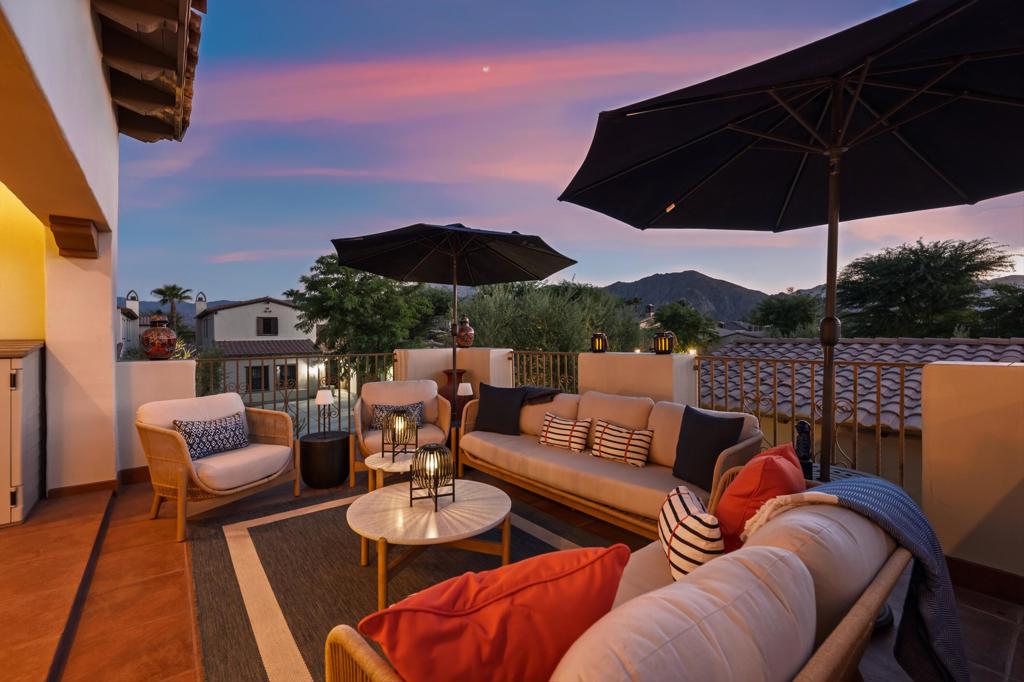 Dramatic Views, Casita & Highly Upgraded! Welcome to 80680 Via Tranquila, a luxurious retreat in the gated enclave of La Cantera in South La Quinta--renowned for its Spanish-Mission architecture, indoor/outdoor living, and stunning views of the Santa Rosa Mountains. Enter through a charming courtyard that sets the tone for the open, light-filled floor plan with soaring ceilings and tile floors throughout the common areas. The great room is anchored by a striking fireplace and features a custom wet bar with wine fridge--ideal for entertaining. The gourmet kitchen boasts granite slab countertops, a 48'' Sub-Zero built-in fridge (5 yrs old), Thermador 6-burner cooktop with hood, double convection ovens, Bosch dishwasher, new incinerator, kitchen faucet, and an upgraded electrical outlets. A sunny breakfast nook and formal dining area offer multiple dining options. Outside, the lushly landscaped backyard includes a fireplace, new landscape lighting, and a sparkling pool with raised spa and waterfall. A new Pentair pump, skimmer, and filter were installed within the past 3 years. The home includes 2 bedrooms, 3.5 baths, and a detached casita with wet bar and ensuite--perfect for guests or a private office. Upstairs, a spacious loft with surround sound, wet bar, and a fireplace-adorned balcony delivers breathtaking mountain views--ideal for relaxing or entertaining. Additional upgrades include two newer (4-year-old) American Standard Platinum A/C systems, a tankless water heater (4 months old), ADT security system, new garage door springs/wires, and new exterior lighting. Low HOA of $360/mo includes gated access, front yard landscaping & water, trash, and community lighting. Minutes to Old Town La Quinta, top-tier golf, and within walking distance to the Coachella & Stagecoach festivals. Built in 2005 and offering approx. 2,929 SF of well-designed space, this home is a rare blend of thoughtful upgrades, mountain views, and effortless desert living.
