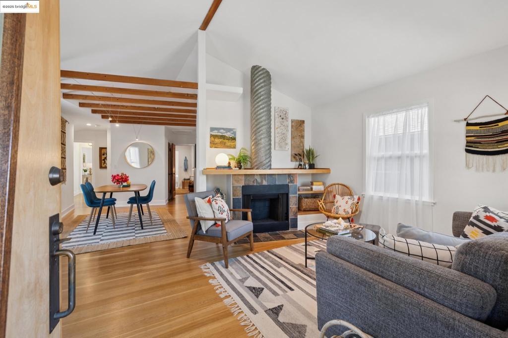 Tucked on a friendly street, this isn’t your ordinary 1940s Berkeley home—it’s a whimsical mid-century reimagine. A simple front gable and covered porch keep things classic, but step inside and it’s all about the unexpected. The living space opens up with cathedral ceilings and exposed rafters, giving you that rustic lodge-meets-urban loft vibe. Beneath it all? Warm hardwood floors that tie the space together with an easy, timeless feel. Upstairs, the primary suite is your private retreat with a west facing balcony made for morning coffee, evening wine, and sneaky midday sun breaks. The backyard is a sweet little sanctuary: a gravel path looping through mature plantings in the shade of a Redwood. Rustic and playful, practical and stylish, cozy and airy—all at once. And the location? It hits the sweet spot! Wander to Acme Bread, and grab a dinner bottle at Kermit Lynch on the same block. Cedar Rose Park is your outdoor living room; the Ohlone Greenway is your easy bike path for errands, exercise, or leisure. Green thumbs will love Westbrae Nursery, and Berkeley Bowl West is a quick ride away. Just a ½ mile to North Berkeley BART and with a Walk Score® 84 and Bike Score® 97 leave the car in the garage, perhaps forever!