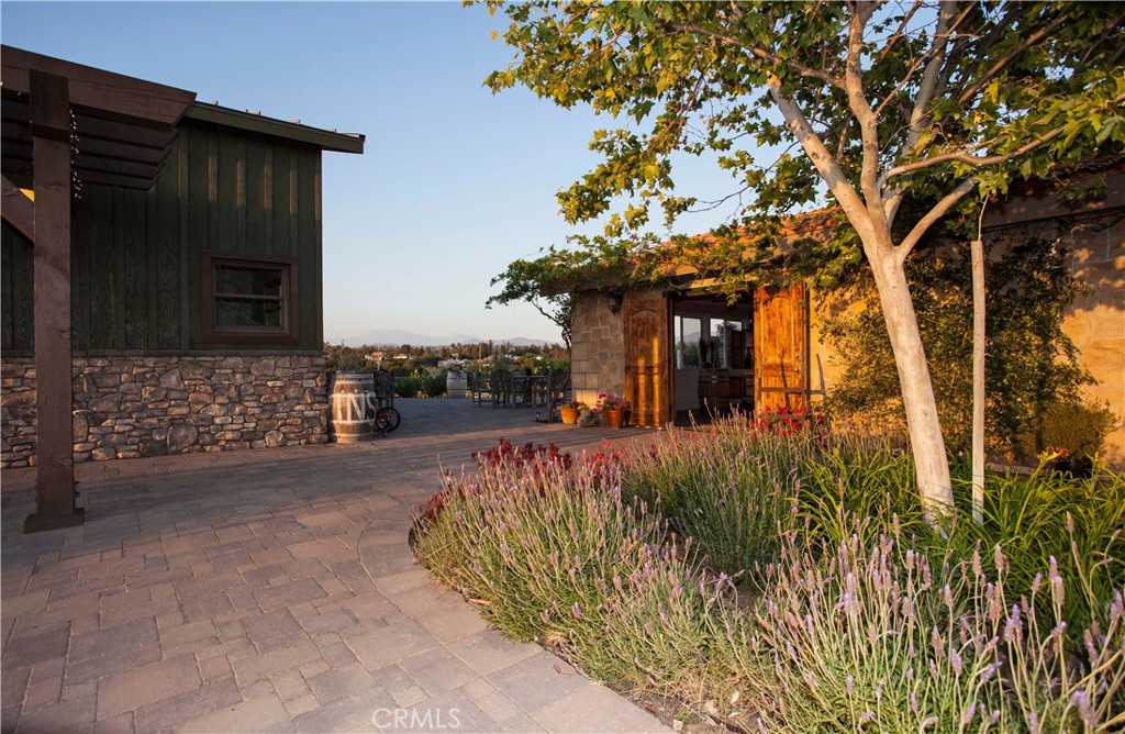 Palumbo Family Vineyards & Winery is an exceptional offering in the heart of Temecula’s prestigious wine country, presenting a rare opportunity to own a fully operational boutique winery with a well-established reputation for producing handcrafted, small-lot wines from sustainably farmed estate vineyards. Spanning over 12 gently rolling acres, the property features meticulously maintained Cabernet Sauvignon, Cabernet Franc, Sangiovese, and Merlot vines that reflect the Palumbo family’s commitment to quality and sustainability.
The winery facilities total approximately 4,200 square feet and include a charming tasting room, climate-controlled production and storage areas, barrel rooms, and inviting event spaces ideal for hosting private gatherings, wine club events, or intimate celebrations. The property also includes a beautiful single-level residence of approximately 2,400 square feet, offering three spacious bedrooms and two bathrooms. The home is thoughtfully positioned to capture panoramic vineyard views and breathtaking sunsets, with an entertainer’s backyard featuring an outdoor fireplace, built-in BBQ, covered gazebo, and a luxurious infinity-edge pool overlooking the vines.
With a profitable winery operation, a loyal wine club, strong direct-to-consumer sales, and a turn-key residence on-site, this is a rare chance to step into an established and respected brand in one of Southern California’s most vibrant wine destinations. Whether you’re an investor, a vintner at heart, or seeking a lifestyle property that blends business with pleasure, Palumbo Winery offers a truly special place to live, work, and create world-class wine.