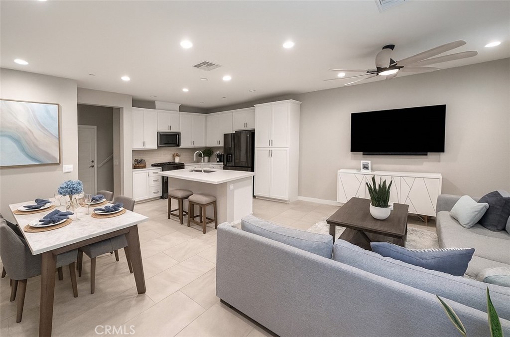 Stylish Modern Farmhouse Townhome in Ontario! Beautifully designed with a stylish farmhouse exterior, this 2022 Shea Homes townhome offers an inviting open-concept floor plan perfect for modern living. The main level features luxurious tile flooring throughout the living, dining, and kitchen areas, creating an elegant and seamless entertaining space. A gourmet kitchen with quartz countertops, crisp white cabinetry, and stainless-steel appliances is ideal for gathering with family and friends. Upgraded carpet enhances the stairs, upper hallway, and bedrooms. The spacious primary suite boasts soaring ceilings, recessed lighting, a ceiling fan, and an oversized walk-in closet. Its spa-like ensuite includes a dual vanity, a beautifully tiled walk-in shower, and a private water closet. Two additional bedrooms, a hall bath with dual sinks and a separate wet area, plus a convenient upstairs laundry room complete the second level. This home also includes a two-car direct access garage with an insulated roll-up door and EV charger, adding comfort and convenience. Paid-off solar panels and a tankless water heater maximize energy efficiency, while a low-maintenance front patio provides the perfect spot to relax outdoors. The community itself is thoughtfully designed with private amenities to enrich the Southern California lifestyle. Enjoy a sparkling pool, spa, splash pad, fire pit, BBQ and picnic areas, and a tot lot for little ones. Ideally located near excellent shopping, dining, recreation, and healthcare in Ontario, with the added convenience of Irvine’s metropolitan amenities just a short drive away.