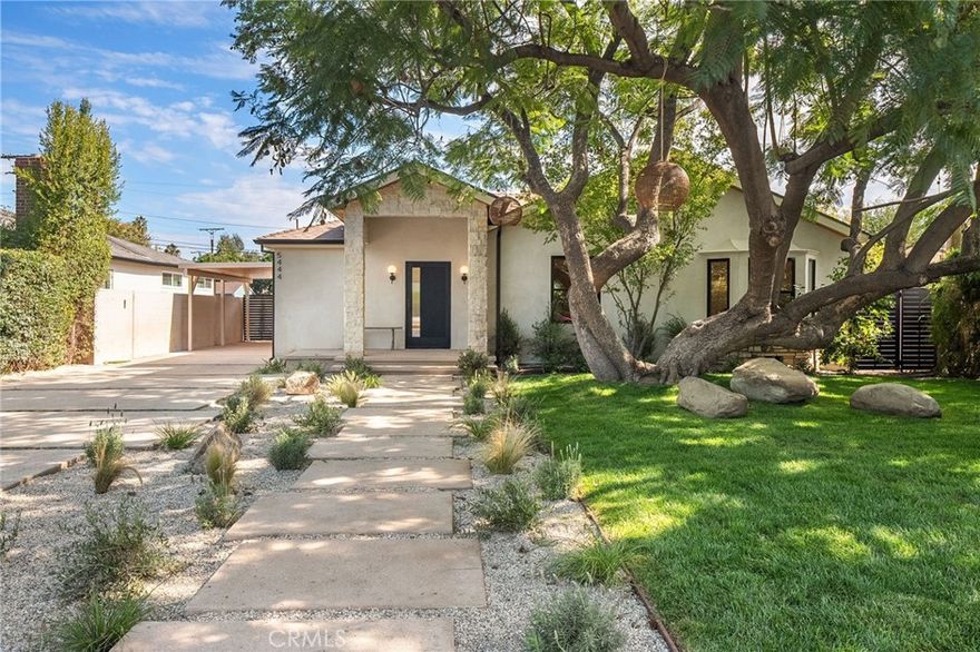This beautifully reimagined home sits gracefully on a quiet street in one of Valley Village’s most desirable neighborhoods. Thoughtfully redesigned from top to bottom, the 3-bedroom, 2.5-bath residence showcases sophisticated design, natural light, and seamless flow throughout its open-concept layout. The inviting living room, anchored by a cozy fireplace, connects effortlessly to the dining area and a chef’s kitchen featuring a large island, custom White Oak cabinetry, Taj Mahal quartzite countertops, and premium appliances — the perfect setup for gatherings and everyday living. Sliding doors open to a spacious entertainer’s backyard featuring a brand-new pool and spa, surrounded by lush greenery and ambient landscape lighting that create a private, resort-like retreat. The primary suite offers direct access to the backyard and a spa-inspired bath with a freestanding soaking tub. Each bedroom is spacious and filled with natural light, offering comfort and versatility for family, guests, or creative use. The home also features a dedicated laundry room with ample storage, carport parking, and a detached 1-bedroom ADU showcasing high ceilings and abundant natural light.. The property’s extended driveway provides generous parking for several vehicles, including space for an RV. Set on an expansive 8,100 sq. ft. lot, this 2,600 sq. ft. property blends modern luxury with timeless warmth, offering exceptional design and functionality in one of Valley Village’s most desirable neighborhoods — just moments from a House of Worship.
