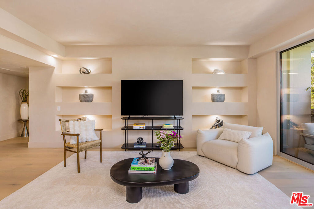 Full Service/24 Hour Secure Doheny Plaza with doorman, valet, resort style pool/gym and situated across from the Beverly Hills Flats on the prestigious Doheny Dr. HOA covers all utilities (AC/heat, water, and electricity) The property is fully furnished and just completed a 2024 warm, earthy remodel with the most luxurious materials. The double door entry leads to high ceilings, custom built-ins, natural light, and patio views of the Hollywood Hills through the sleek sliding glass doors. The oversized kitchen has a custom bar area that opens to the living room that is perfect for entertaining guests. The kitchen boasts all new Top-of-the-line Fisher Paykel appliances w custom coverings, an induction range, and with beautiful custom cabinets, and Taj Mahal Quartzite countertops with custom stone shelves. The custom bar has a built-in wine fridge and glass cabinet, adding a touch of indulgence to your daily life. Roman Clay throughout the living room and kitchen was done by a designer featured in Vogue. The bathrooms have travertine flooring/baseboards, European fixtures, faucets, integrated sinks, and Taj Mahal Quartzite, custom cabinetry. Kelly Wearstler's lighting throughout the home adds a unique touch. Additional updates include custom solid wood closets in bedrooms, wide oak floors, all new windows/doors, new air conditioning, and plumbing/electrical brought up to 2024 codes with permits. The building recently underwent a major million-dollar renovation. Welcome home to luxury living in the heart of West Hollywood close to Beverly Hills, Soho House, The Edition, and the best Restaurants and Nightlife this city offers.