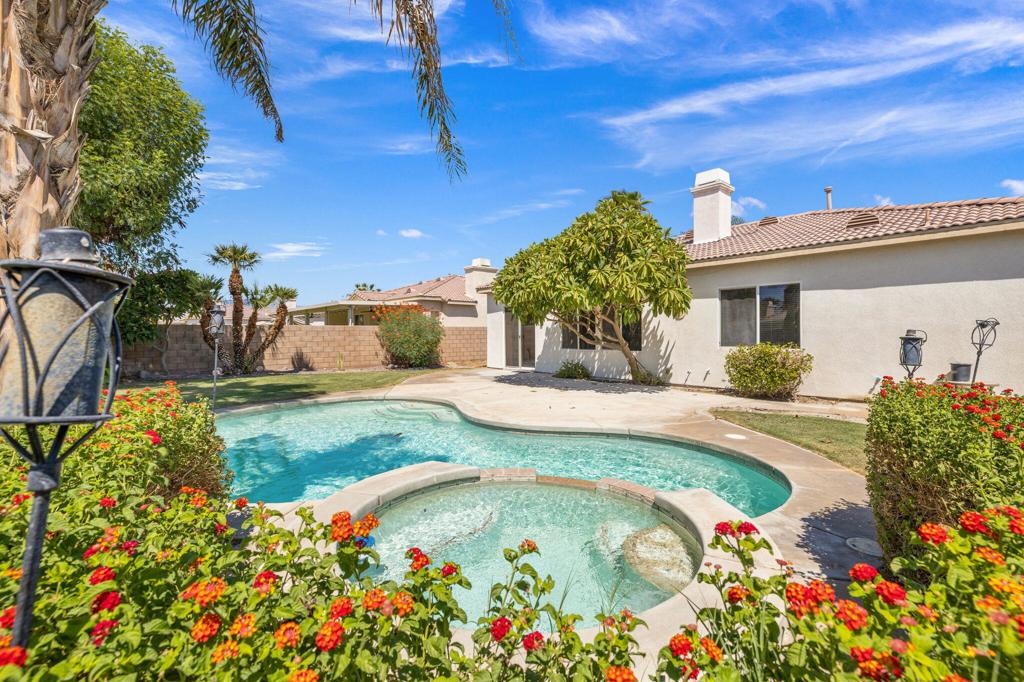 This is the perfect opportunity to own a well-maintained home in the sought after Sunburst neighborhood of Indio. This large 1,836 square foot home offers 3 bedrooms, 2 baths, plus a large den / office that could be used as a 4th bedroom. The home sits on a beautiful 8,712 square foot lot with a landscaped, grassy yard, sparkling pool and waterfall spa. Built in 2005 the home has been recently refreshed to include new interior paint, new carpet in the living room and bedrooms, and new ceiling fans throughout. The kitchen has all new stainless-steel appliances including a French door GE refrigerator, GE dishwasher, new GE 4 burner gas stove with a 5th burner-griddle and a microwave-hood fan. The kitchen with adjoining breakfast area also opens to a dining area and the living room. The open living room has a gas fireplace; ceiling fans and overlooks the beautiful back yard. Enter the large primary suite through double doors. The primary bath offers dual sinks and a tub shower combination and walk in closet. The 2 additional bedrooms share a central hall bath that also has dual sinks and a tub shower combination. The laundry room includes a washer and dryer with direct access to the two car garage for direct entry. There is no HOA and short term rentals are allowed so this is not only a perfect opportunity to purchase your new home but it could also make a great short term rental during the Coachella and Stage Couch spring festivals.