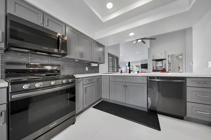 COMPLETE REMODEL & REIMAGINED OPEN-CONCEPT FLOOR PLAN!&#8232;This striking ''Upper Level Villa'' showcases soaring vaulted ceilings, crisp modern design, and direct mountain views. The entire interior has been beautifully transformed in a six-figure renovation, offering a turn-key lifestyle where every detail has been thoughtfully curated -- just bring your luggage and enjoy. Gleaming white tile floors flow seamlessly throughout, creating a bright, airy atmosphere enhanced by recessed LED lighting and designer ceiling fans.  The expanded kitchen features sleek Quartz countertops with counter-height bar seating for four, upgraded cabinetry with soft-close drawers, and black stainless appliances -- including a single-basin sink and wine fridge at the custom wet bar. A French door opens to a private front patio facing east, perfect for enjoying your morning coffee in the sun or a quiet outdoor meal. The adjacent dining area offers flexible use -- ideal for formal dining, casual entertaining, or even a game space for billiards or ping pong.  The living room's fireplace adds warmth and charm, with sliding glass doors leading to a private rear patio where you can relax and take in beautiful mountain vistas. The spacious primary suite has been updated to include a luxurious spa-inspired bathroom with a large tiled shower and bench, Quartz vanity, and premium fixtures. A second updated bath serves guests with equal style.  Additional features include a separate in-unit laundry room, private double-car garage, and a new 2024 water heater. This villa is conveniently situated near one of the community's large pool and spa areas -- perfect for enjoying the resort atmosphere right at home.  Desert Falls Country Club offers residents access to the highly rated Scottish Links Championship Golf Course -- a Golf Digest 4-Star ''Best Places to Play'' course -- with both ''pay as you play'' and membership options available. The gated community includes 30+ pools and spas, tennis, pickleball, fitness center, clubhouse with dining and social events, cable, Wi-Fi, building maintenance, and 24-hour security -- all included in your HOA dues.  Centrally located in Palm Desert near fine dining, shopping, and entertainment, just minutes from Acrisure Arena, Agua Caliente Spa & Casino, Indian Wells Tennis Garden, McCallum Theatre, and the El Paseo Shopping District -- the desert's premier luxury shopping and dining destination. Short-term rentals permitted!