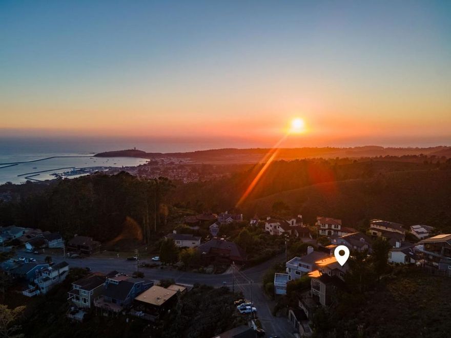This "castle in the sky" captures sweeping coastal views from the Ritz Carlton to Mavericks! Perched in the El Granada Highlands, it offers unencumbered sightlines and easy access to Quarry Park's panoramic trails. Inside, soaring cathedral ceilings with exposed beams and a large skylight create an airy, spacious feel that echoes the openness of the surrounding landscape. The main level centers on a chef's kitchen with adjacent dining area, family room, formal living room, and music room with baby grand piano. The top-level primary suite is a private retreat with forest and ridgeline vistas, a home office, walk-in closet, and a spacious bath with a Japanese soaking tub - ideal for a relaxing soak or invigorating cold plunge. The lower level, with private entrance from the elevator or stairs, offers excellent potential as a second unit with a separate living area, kitchenette, full bath, and bedroom with direct backyard access. Energy resilience comes from a 10.47 kW Solar Roof (2020, NEM 2 rights) paired with two 13 kW Powerwalls. Dramatic views, strong bones, and quality systems await your finishing touches. Minutes to Surfers Beach, harbor dining, and downtown Half Moon Bay, 107 Dolphine Avenue delivers an elevated coastal lifestyle above the Coastside's most iconic views.