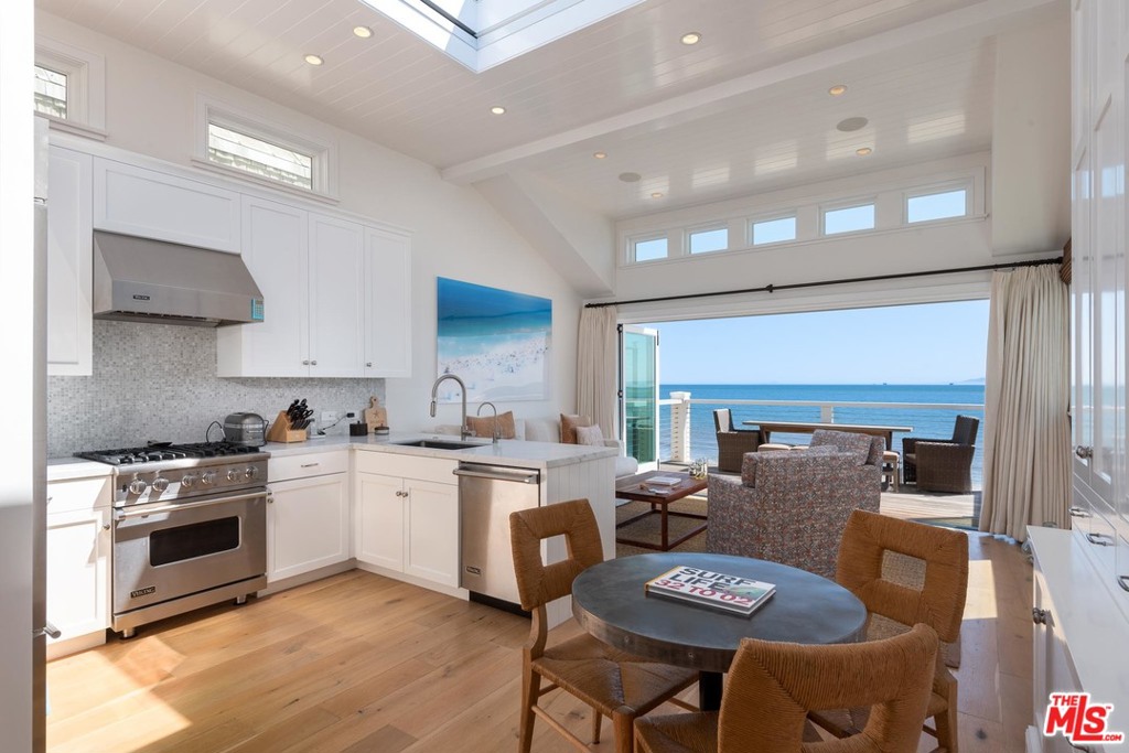 Located on a private, gated lane on Montecito's revered Miramar beach and a stone's throw from the new Rosewood Miramar Hotel, rests this impeccably-renovated beach house. The beachfront homes on Miramar Beach are treasured in the community and rarely turnover ownership. This home, in particular, distinguishes itself as one of the few that have been so generously updated, with an extensive list of modern conveniences and amenities. The home consists of three levels, each featuring high-end materials and finishes and sets of bi-fold doors opening to balconies overlooking the beach. The entry and top level features a unique retracting skylight, ensuring ample natural light and serves as a continuation of the beach living. The top level also offers a half bathroom, kitchen with top-of-the-line stainless steel appliances and comfortable living space which flows seamlessly to the balcony. The master bedroom suite sits on the mid-level and is complete with a spacious bedroom and bath.