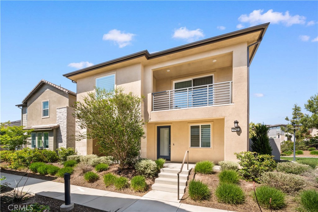 Step into contemporary elegance with this stunning end-unit detached two-story home, ideally situated next to a lush greenbelt in the vibrant Great Park Neighborhoods of Irvine. Offering a 4-bedroom, 3.5-bath residence with a spacious loft that blends sleek modern design with exceptional functionality.From the moment you enter, you're greeted by an expansive open-concept great room awash in natural light—an inviting space perfect for both everyday living and entertaining. At the heart of the home is a chef-inspired kitchen, featuring a generous center island, quartz countertops, stainless steel appliances, a built-in refrigerator, and soft-close cabinetry. A main-floor bedroom with its own en-suite bath provides a flexible option for guests, multigenerational living, or a private home office. Upstairs, the luxurious primary suite serves as a tranquil retreat, complete with a private deck, a large walk-in closet, and a spa-like bathroom with a soaking tub and separate glass-enclosed shower. Two additional bedrooms, a full bath, and a versatile loft offer ample space for the entire family. Enjoy resort-style living with access to Rise Park and the greater Great Park Neighborhoods’ exceptional amenities: Pools and Spas, multiple parks, clubhouses, playgrounds, walking trails, basketball courts, picnic areas, and even a community greenhouse. Located within the award-winning Irvine Unified School District—just minutes from top-rated Solis Park K-8 and Portola High School—and a short drive to premier shopping and dining at Woodbury Town Center and Irvine Spectrum. Don’t miss the opportunity to own this move-in-ready gem in one of Orange County’s most sought-after communities!