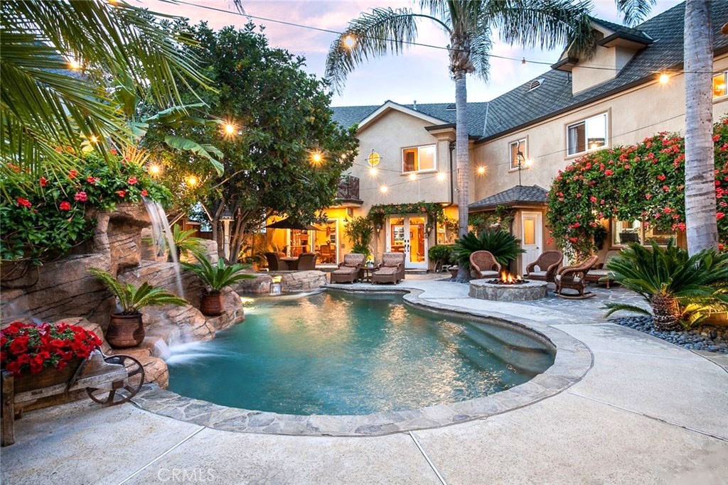 NEWPORT HEIGHTS PARADISE! Experience the epitome of resort-style living in this impeccable entertainer's dream home with attached 3-car tandem garage with space for a workshop. The backyard is your own personal oasis with pool, spa, water slide & waterfall, all surrounded by outdoor living areas that define sheer luxury. Spend your evenings grilling in the backyard's covered gourmet kitchen and relaxing in the indoor sauna. Featuring a recently remodeled chef's kitchen that includes stunning granite counter tops, Alder wood cabinets, a 6-burner Wolf range, Sub-Zero refrigerator & Thermador double oven. The first level has an open floor plan blending indoor and outdoor living spaces and a separate great room and home theater. The second level houses two spacious master suites, each with en-suite bathrooms and walk-in closets, as well as two guest bedrooms. Tucked away at the end of a cul-de-sac, this incredible home showcases meticulous craftsmanship, top-of-the-line amenities, and is situated in a premium location near the beaches & amazing restaurants & shopping at nearby 17th Street & Lido Village. This one-of-a-kind estate in the Newport Heights school district affords all the luxuries of the premier coastal lifestyle. *House is staged virtually and does not include furniture.
