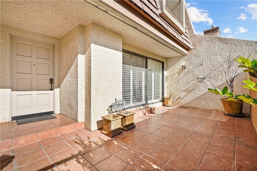 Welcome to this beautifully updated split-level townhome in highly sought-after gated Tarzana Villa North. From the landscaped, secured entrance, to the home’s thoughtful multi-level layout and abundant natural light, it offers rare privacy and comfort.  
A spacious tiled private patio extends your living space, ideal for morning coffee, outdoor dining, or relaxing outdoors. Inside, you’ll find high ceilings, rich hardwood floors, custom plantation shutters, central air and heat, modern Minka Aire ceiling fans in every room, custom wrought-iron stair railings, wainscoting (wall paneling), crown molding, and crisp white walls for an airy, designer feel across all levels.
The elevated dining area overlooks the large living room, creating an open, architectural flow.  The kitchen offers generous granite counters, white cabinetry, a wide breakfast bar, custom millwork, and an included Jenn-Air refrigerator in excellent working condition. A spotless, beautifully maintained powder room completes the main level. All appliances, including a near -new matching washer and dryer (pictured) are included. 
The existing fireplace is decorative; a buyer may choose to replace it or install an electric or modern gas unit.
 
Upstairs, the oversized primary suite easily fits a king bed and seating area.  It features a large walk-in closet with full custom-built-ins, and premium Berber-style carpet.  The ensuite bath includes a long double-sink vanity, separate makeup area, and a private water closet with walk-in shower. 
The second bedroom has high ceilings, a custom cedar-lined closet with added cabinetry and a balcony overlooking the pool – a rare highlight in this community.  A beautifully tiled full bath with natural stone and a tub shower combo serves this room and the upstairs hall.  

Recent upgrades include:
• New washer and dryer.
• New water heater.
• New Genie garage door opener with 3 remotes.
• New Nest smart thermostat with wi-fi.
• New AC installed in 2017
 
Everyday conveniences set this home apart: mail is delivered directly into the garage via mailslot, and trash pickup is right outside your garage door - no long walks to mailbox clusters or shared trash areas. The building is gated and secure with well-kept grounds.