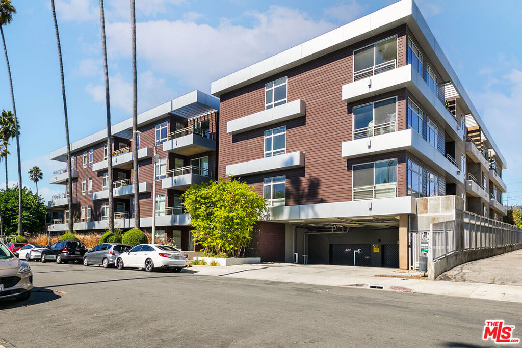 Experience modern luxury in the heart of Hollywood. This stunning 2-bedroom, 2-bathroom condo blends style, comfort, and sophistication with an open-concept layout designed for today's lifestyle. The high-end kitchen with an island anchors the main living space, seamlessly connecting the built-in office area, dining nook, and living room. Step outside to your private outdoor patio, an expansive retreat ideal for entertaining or dining al fresco. Both bedrooms are generously sized with tall ceilings and ample closets, while the primary suite offers a spa-like escape complete with a rainfall shower and soaking tub. Additional highlights include in-unit laundry, outdoor storage, and two tandem parking spaces. Enjoy resort-style amenities with a state-of-the-art fitness center, secure entry, and an unbeatable location close to everything Hollywood has to offer. Spend Sundays at the Hollywood Farmers Market, catch a show at The Fonda Theater, and explore endless dining and shopping options. All just minutes away. Conveniently located near major studios and offices like Netflix, this home combines the best of city living with modern comfort and privacy. Modern design, luxury finishes, and prime location, this is Hollywood living at its finest.