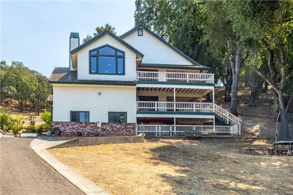 Perched on a scenic hilltop in Westside Atascadero, this 3-bedroom, 2.5-bath home offers over 2,400 sq ft of living space + bonus room (not included in square footage) on nearly an acre! With unparalleled views of North County’s rolling hillsides, vines, and even the Pinnacles in the distance, from sunrise to sunset, this property captures the very best of Central Coast living. Outside, there’s space for RV or boat parking, a bountiful hillside garden, and a front yard overlooking the same views. Multiple covered decks provide the perfect place to sip coffee, host gatherings, or simply breathe in the beauty & views around you. Inside, the main level features two guest bedrooms, each with its own slider to a viewing deck, and a full bathroom with a dual sinks. Also on this level is a laundry room and a bonus room currently being used as an additional bedroom. The living room is a showstopper, highlighted by vaulted wood-beamed ceilings, a warm brick-surround wood-burning fireplace, and a large picture window framing those “forever” views. The updated kitchen is a chef’s delight, boasting a subway tile backsplash, sleek quartz countertops, 5-burner gas cooktop, farmhouse sink, built-in wine rack, and walk-in pantry — all flowing seamlessly into the dining and living areas. Privately set on this same level is the primary suite, a true retreat with a private deck, a spa-like en suite featuring a granite countertop double vanity, soaking tub, walk-in shower, dual closets and a roomy linen closet. Nearby is also a laundry chute for convenience, plus the home is equipped with a central vac system. Out back, multiple tiered decks lead to the sun-soaked garden, perfect for unwinding or entertaining under the open sky. With its elevated setting, thoughtful updates, and unmatched views, this home is a rare Westside gem — one you won’t want to miss.