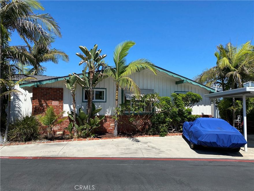 Beach Lovers Delight!  Close proximity to beautiful Huntington Beach, Pier, Downtown, Shopping and Dining.  This home offers an interior corner lot and is like no other, Professionally landscaped, **3 car parking**, 2 bedroom, newer roof, newer flooring, updated appliances, plantation shutters, newer windows and a large living/family room to enjoy the fresh air and ocean breeze. Located in the rear of park allowing EZ access to the gate near the beautiful sands of Huntington Beach!  Here's your chance to Buy.  Why Rent? When you can Own?