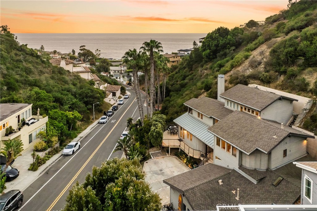 Featuring a fantastic location with the city’s famous Victoria Beach and Montage resort just minutes away, 426 Nyes Place is a four-bedroom plus den, three-bathroom home offering both seclusion and convenience. Located behind a private gate and spanning approximately 3,300 square feet of living area, this property was positioned to best take advantage of the ocean views. The home's main level features a large kitchen with an eat-in island, stone counters, access to the garage, and plentiful cabinetry space. This floor was designed for gathering, with an adjacent dining area and a sitting nook with French doors leading to the side patio. The living room with views of the Pacific offers a fireplace as well as access to the home’s wraparound deck - ideal for enjoying sunsets. A bedroom with an adjacent bathroom completes the main level. The remaining bedrooms of the home are located on the second level, with the ocean-facing primary suite featuring a balcony, a five-piece bathroom, and a spacious walk-in closet. The secondary bedrooms are ample in size and share a large bathroom. The top-level features an airy loft-style den with access to another of the home’s balconies and is large enough to be utilized as a multipurpose space. Desirable location with the conveniences of Laguna Beach nearby and easy access to Dana Point.