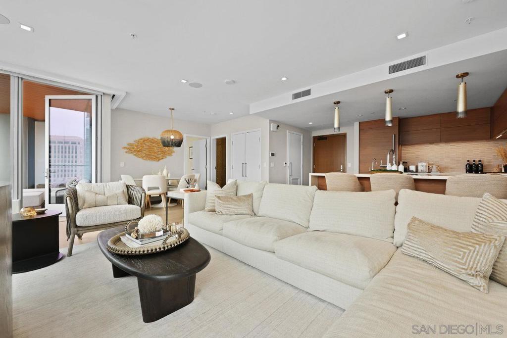 Completely remodeled turnkey luxury residence at iconic Pacific Gate. Available August 1, 2025. Expanded living area and top-tier designer furnishings complement panoramic views from San Diego Bay to evening lights. Flooded with natural light, the open-concept layout features a chef’s kitchen with Caesarstone counters and high-end appliances. The primary suite offers stunning water views and a spa-inspired bath with soaking tub, glass-enclosed shower, and LED-lit mirror with built-in TV. Smart home tech controls lighting, climate, and motorized shades. Enjoy morning coffee or evening sunsets from your private balcony. Exceptional amenities include 24-hour concierge, resort-style pool with cabanas, outdoor kitchen, resident lounge, screening room, business center, luxury car fleet, yacht share, on-site dining, and easy access to the waterfront, fine dining, shopping, and entertainment. Live at the crossroads of comfort, convenience, and coastal elegance—welcome to life at Pacific Gate.