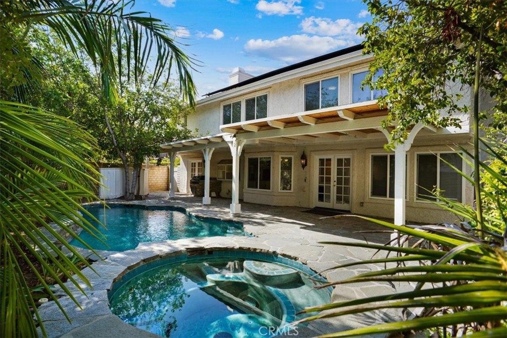 Charming 5-bedroom, 3-bath home for lease in a desirable Agoura Hills neighborhood. Tucked at the end of a quiet cul-de-sac, this property offers privacy, an open layout and a backyard built for fun with a pool, spa, and covered patio. Inside, soaring ceilings and large windows brighten the living room, while the kitchen features granite counters, stainless appliances, double oven, island cooktop, walk-in pantry and a sunny breakfast nook. The family room includes a fireplace, wet bar and French doors opening to the yard. There is also a bedroom and full bathroom downstairs for convenience. Upstairs, the primary suite offers a walk-in closet and bathroom with dual sinks, separate tub and shower. One of the secondary bedrooms has a built-in desk—ideal for a home office or study space. With award-winning Las Virgenes schools plus nearby shopping and dining, this home offers both comfort and convenience. Relatively close proximity to the 101 freeway, hiking trails and a 20-minute drive to the beach are other perks of living in this amazing location. Don't miss the opportunity to make the amazing house your new home.