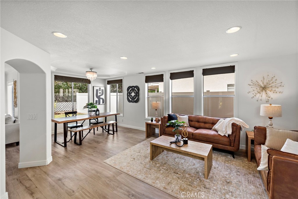 Welcome to this beautifully updated 4-bedroom plus loft home, ideally located on a corner lot in the desirable Wagon Wheel community. Step inside to find stunning wide plank tile flooring throughout the main level and a modern, open-concept floor plan that seamlessly connects the living room, dining area, and updated kitchen. The kitchen is a chef’s dream with crisp white cabinetry, sleek quartz countertops, and plenty of space for entertaining. Downstairs also features a stylishly upgraded powder room, a convenient laundry room, and direct access to a two-car garage. Step outside to your private backyard retreat, complete with a spacious covered patio, cozy firepit, and a large grassy area—perfect for relaxing or entertaining. Upstairs, you'll find a versatile loft space (or create a 5th bedroom) and four generously sized bedrooms. The light-filled primary suite offers a luxurious ensuite bathroom with dual vanities, a separate soaking tub and shower, and a walk-in closet. The secondary bedrooms are all light and bright with ample closet space, and the Jack and Jill bathroom has been tastefully renovated with modern tile work and a dual-sink vanity. Freshly painted in a clean, modern white palette and repiped with Pex for peace of mind, this home combines style, comfort, and function. With space behind thanks to the serene greenbelt, this location offers privacy and a sense of tranquility. Don’t miss your chance to tour this incredible home—schedule your showing today!