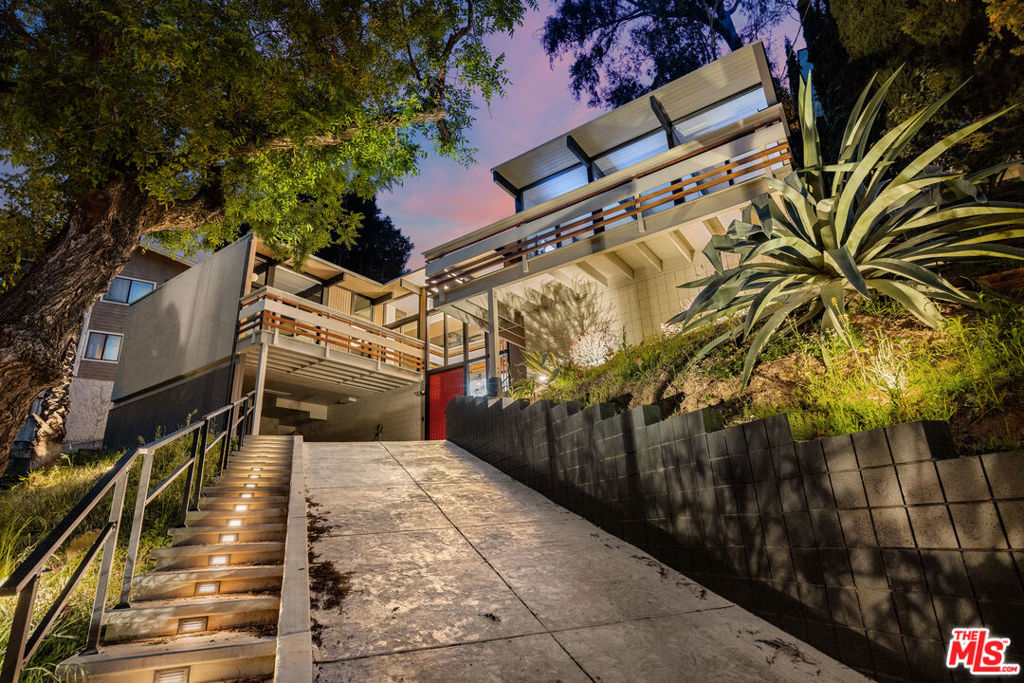 Perched in the hills south of Ventura Boulevard, 3905 Pacheco Drive is a true Sherman Oaks Architectural trophy property, blending mid-century architecture with modern updates. This three-bedroom, three bath home offers soaring beamed ceilings, walls of glass, and seamless indoor-outdoor flow. The remodeled kitchen features custom cabinetry, quartz counters, and high-end appliances, opening to light-filled living spaces.The primary suite leads to a private redwood deck with serene hillside views. Updated systems, a two-car garage, and a flexible bonus room add to its appeal. The front and back yards have been completely redone with rock wall and jacuzzi (craned in!). Ideally located moments from the best of Sherman Oaks, this is a home that balances design, comfort, and location to perfection. This is a very special home; we need not say more.