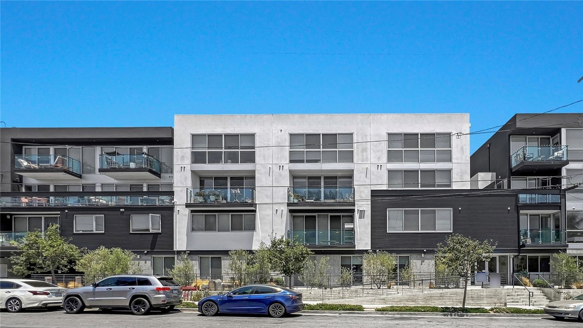 Modern luxury meets rare outdoor living at Residence 103 in 957 Figueroa Terrace. Set in a sleek 2020-built structure with concrete walls and floors, this 2-bed, 2.5-bath ground-level condo delivers a minimalist aesthetic with premium finishes. The open layout features a chef’s kitchen with Bertazzoni appliances, quartz waterfall island, Pedini cabinetry, and floor-to-ceiling sliding glass doors that create seamless indoor-outdoor flow to your private patio. Both upstairs bedrooms include en-suite baths and walk-in closets, with skyline and treetop views. Gated access, 2-car parking with EV charging, a fitness room, and a BBQ lounge round out the amenities. Tucked into Victor Heights near Echo Park and DTLA, Unit 103 is a rare opportunity to live in a contemporary concrete-style home that blends privacy, design, and urban convenience.