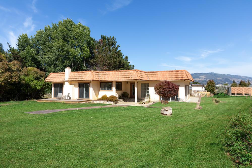 Do you dream of owning flat, open land for your crops, flowers, animals, and/or revenue-producing projects? This property boasts 5 pristine acres in the serene Amesti community. Living on this working ranchette, you'll be near Hwys 1 and 152, public bus lines, beaches, shopping, wineries, restaurants, Pinto Lake Park and County Fairs. This 1949 single-level, Spanish-style ranch house offers 2 bedroom suites with private bathrooms (one newly remodeled), fresh paint throughout, new bedroom carpet, a nearly-500 sq. ft. living room with mini barperfect for your gatherings or relaxing with scenic views. Abundant, cheerful natural light, functional layout, and open floor plan. A spacious, skylit kitchen offers ample storage, cooktop and double built-in wall oven, space for two ranges, a kitchen nook, and breakfast bar. Gather in the large dining space off your kitchen, or enjoy it as a 2nd living room with cozy wood-burning stove. Fenced property features outbuildings, two pastures, stalls, horse paddocks and arena, hay storage, chicken coop, and dog kennels. Oversized 2-car garage offers built-in cabinets and workshop space. Here you'll find opportunities for innovation/expansion, upside investment potential, and creative revenue-generating options. Grab this gem and make it yours!