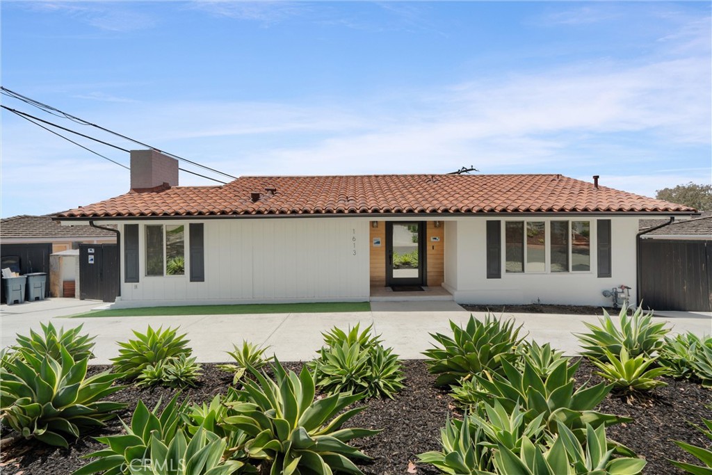 Nestled in the heart of Lunada Bay on a quiet street, this beautifully remodeled 4-bedroom, 4-bathroom home in Palos Verdes Estates blends timeless character with crisp modern updates and stunning indoor-outdoor flow. From the moment you arrive, the circular driveway offers charm and convenience. Step inside to discover an open-concept layout flooded with natural light, soaring vaulted ceilings, and newly refinished wood floors throughout.
The sleek chef’s kitchen features new white cabinetry, marble-style countertops, stainless steel appliances, a farmhouse sink, pot filler, and dual wine/beverage refrigerators—perfect for entertaining. Just off the kitchen, the open dining area with a modern chandelier and fireplace flows effortlessly into a sun-splashed living room framed by walls of windows and ocean views. Two bedrooms and a stylish full bath complete the main level, along with direct access to an expansive balcony ideal for sunset lounging, grilling, or gatherings under the stars.
Upstairs, the private primary suite offers peaceful views and an en-suite bathroom, while the lower level adds flexibility with two additional bedrooms, each with its own bathroom, a large laundry room with washer and dryer included, and a spacious wood-paneled storage room that doubles as a home library or wine cellar.
The former garage has been transformed into a versatile bonus room with a ¾ bath—ideal for a home gym, playroom, or guest suite. Additional upgrades include new lighting, designer tile, matte black fixtures, custom wall paneling, and modernized bathrooms with dual-sink vanities. Exit through the sliders for an expansive backyard furnished with artificial turf for easy maintenance.
Enjoy multiple gathering zones (and dual-zone central AC), flexible spaces for work or play, and a coastal lifestyle just moments from award-winning schools, Lunada Bay Plaza, trails, and scenic bluffs. This turnkey gem is a rare lease opportunity in one of the Peninsula’s most desirable neighborhoods—available now to call home.